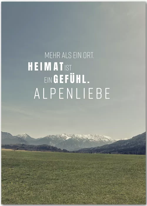 Poster mit Blick über eine Wiese auf die Berge im Hintergrund und Motivationsspruch