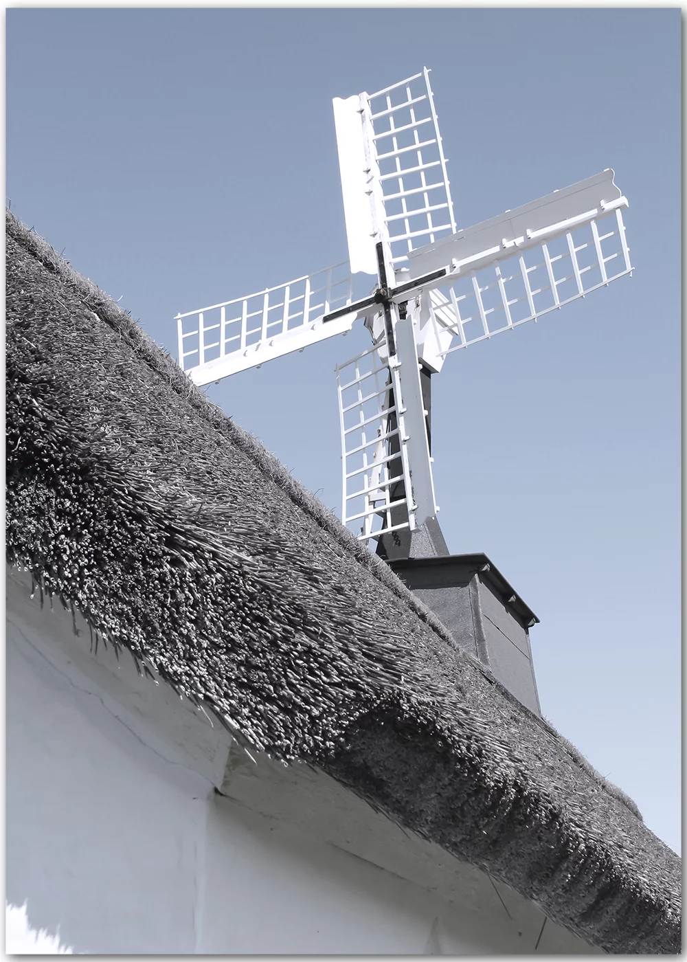 Poster mit einer Windmühle vor blauem Himmel Poster mit einer Windmühle vor blauem Himmel
