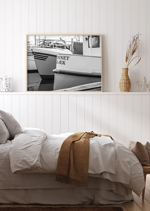 Poster mit Fischerbooten im Hafen von Ålbæk/Dänemark in Schwarz-Weiß über einem Bett